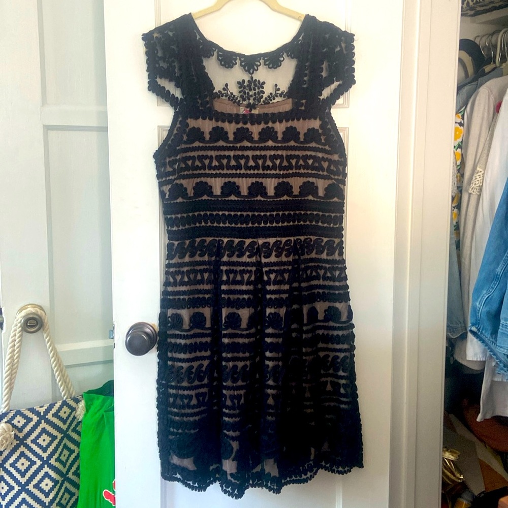 Black cocktail dress. I love the texture, see through elements & scalloped edges